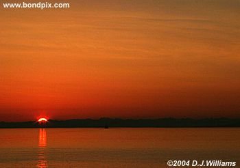 Sun reflected in the water during sunrise over the Inside Passage Alaska