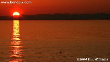 Sun reflected in the water during sunrise over the Inside Passage Alaska